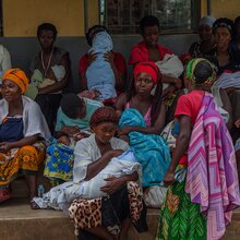 Women and children sitting on benches