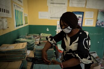 woman in health centre looking through records