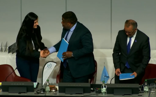 WHO Youth Council representative Kristina Almazidou shakes hands with WHO Director-General Dr. Tedros and IPU Secretary General Mr. Chungong after giving them a formal letter calling for action on health.